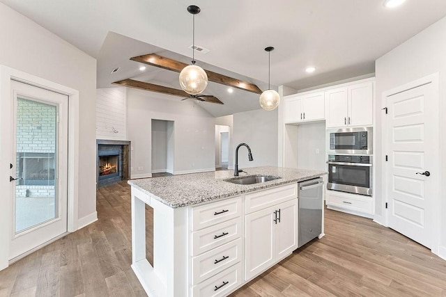 901 Carlock Dr, Pea Ridge, AR 72751 - kitchen with appliances with stainless steel finishes, a sink, beamed ceiling, light stone counters, and hanging light fixtures