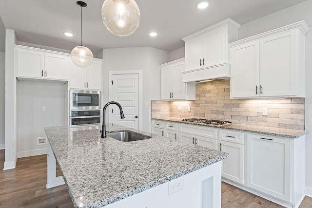 901 Carlock Dr, Pea Ridge, AR 72751 - kitchen with stainless steel appliances, a sink, custom exhaust hood, white cabinets, and a kitchen island with sink