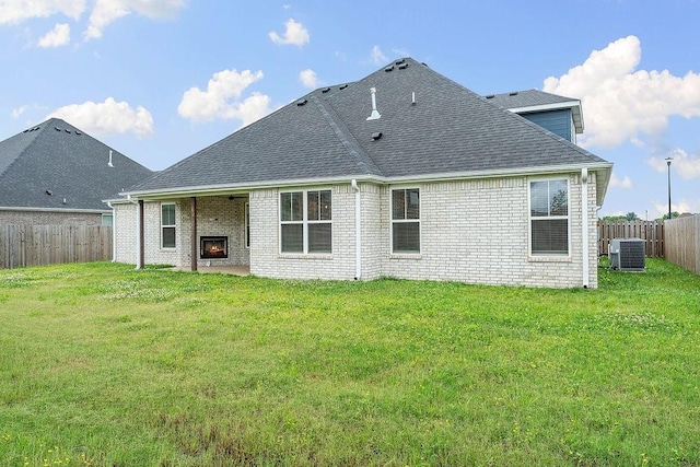 901 Carlock Dr, Pea Ridge, AR 72751 - back of property featuring central AC, roof with shingles, brick siding, and a patio