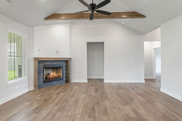 901 Carlock Dr, Pea Ridge, AR 72751 - unfurnished living room featuring a ceiling fan, wood finished floors, a warm lit fireplace, and plenty of natural light