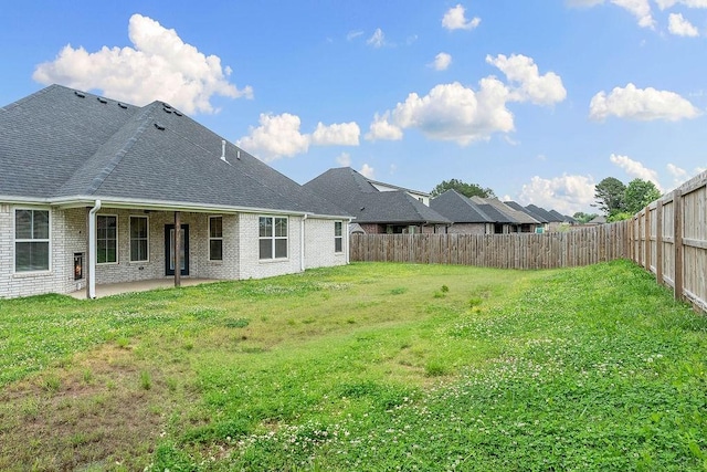 901 Carlock Dr, Pea Ridge, AR 72751 - rear view of house featuring a patio, brick siding, and roof with shingles