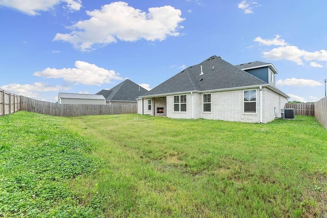 901 Carlock Dr, Pea Ridge, AR 72751 - back of house featuring central AC, brick siding, and a shingled roof