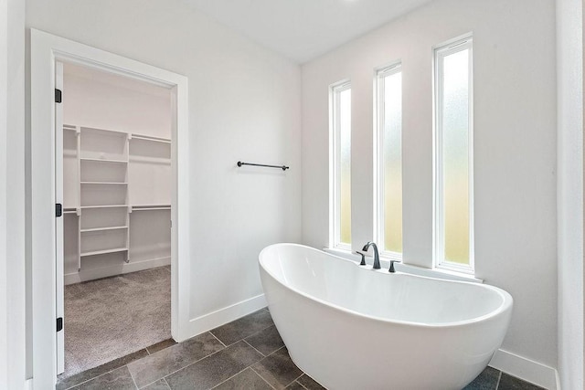 901 Carlock Dr, Pea Ridge, AR 72751 - full bathroom with baseboards, a freestanding tub, and a spacious closet