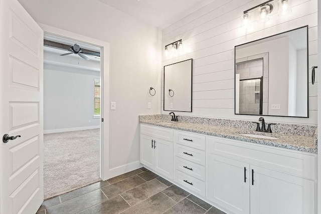 901 Carlock Dr, Pea Ridge, AR 72751 - bathroom featuring double vanity, baseboards, ceiling fan, and wooden walls