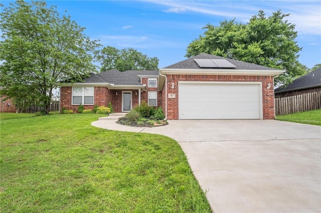 301 Halleck Coach Rd, Centerton, AR 72719 - view of front of house with roof mounted solar panels, concrete driveway, an attached garage, and brick siding