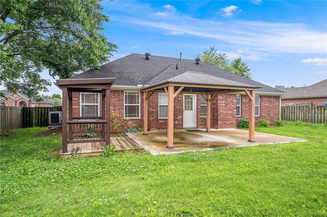 301 Halleck Coach Rd, Centerton, AR 72719 - back of property with brick siding, a patio, a shingled roof, a gazebo, and a wooden deck