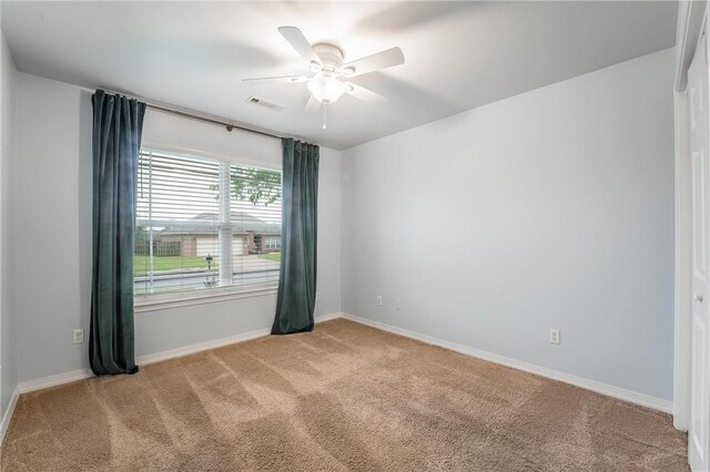 301 Halleck Coach Rd, Centerton, AR 72719 - spare room with light colored carpet, baseboards, and a ceiling fan