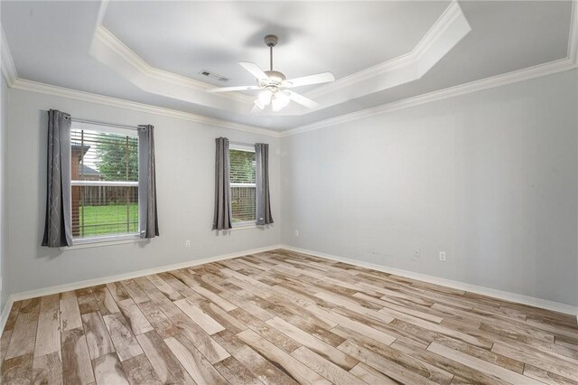 301 Halleck Coach Rd, Centerton, AR 72719 - empty room with a tray ceiling, crown molding, wood finished floors, ceiling fan, and baseboards