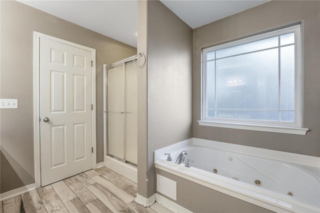 301 Halleck Coach Rd, Centerton, AR 72719 - full bathroom featuring a shower stall, a whirlpool tub, wood finished floors, and baseboards