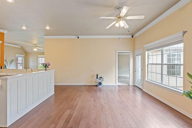 1750 Lancaster Dr, Springdale, AR 72762 - unfurnished living room with a ceiling fan, ornamental molding, light wood-style flooring, recessed lighting, and baseboards