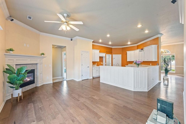 1750 Lancaster Dr, Springdale, AR 72762 - kitchen with white cabinets, ceiling fan, wood finished floors, recessed lighting, and open floor plan