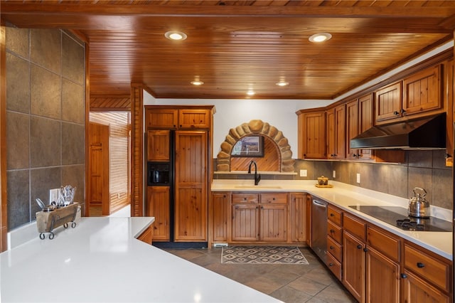 8093 Rockwood Ln, Rogers, AR 72756 - kitchen with under cabinet range hood, black electric stovetop, paneled fridge, stainless steel dishwasher, and a sink