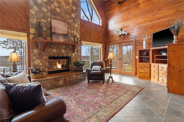 8093 Rockwood Ln, Rogers, AR 72756 - tiled living room with wooden walls, a fireplace, and a towering ceiling