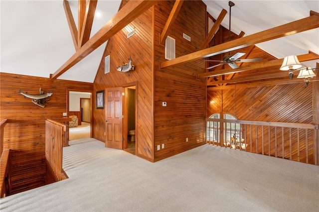 8093 Rockwood Ln, Rogers, AR 72756 - unfurnished room with wood walls, high vaulted ceiling, beam ceiling, ceiling fan, and carpet floors