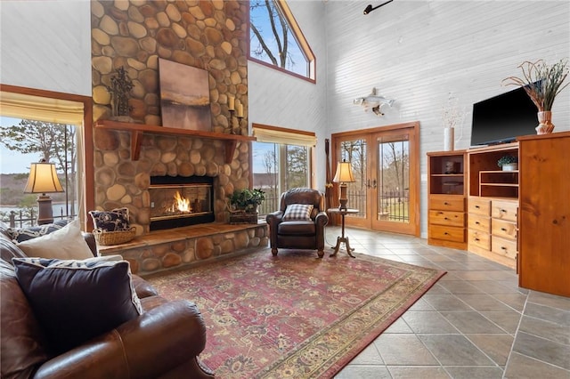 8093 Rockwood Ln, Rogers, AR 72756 - living room featuring a high ceiling, plenty of natural light, a fireplace, and tile patterned flooring