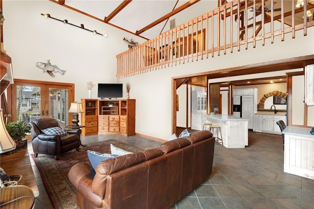 8093 Rockwood Ln, Rogers, AR 72756 - living area with a high ceiling, dark stone finish floors, and baseboards