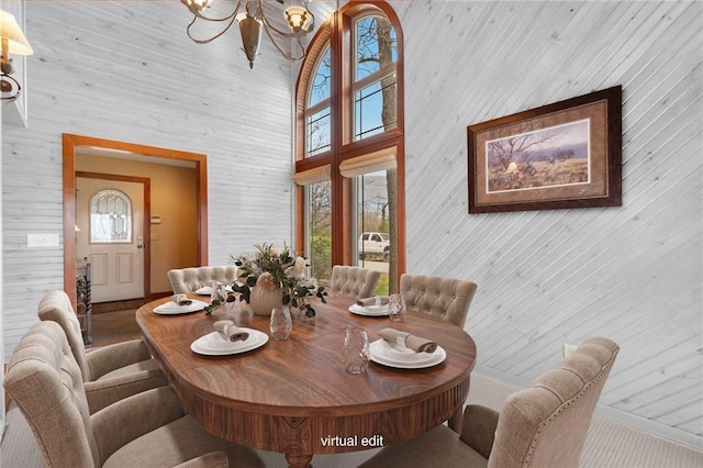 8093 Rockwood Ln, Rogers, AR 72756 - dining room with a chandelier, wooden walls, and a high ceiling