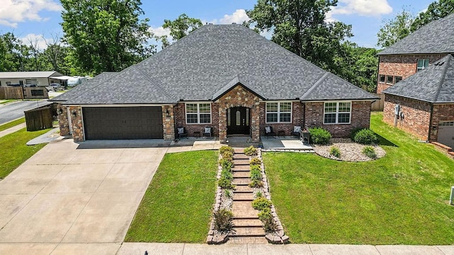 4206 NE Kenton Ave, Bentonville, AR 72712 - view of front of house with an attached garage, a front lawn, driveway, roof with shingles, and brick siding