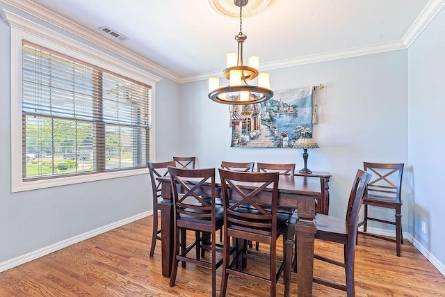 4206 NE Kenton Ave, Bentonville, AR 72712 - dining area featuring wood finished floors, a chandelier, crown molding, and baseboards
