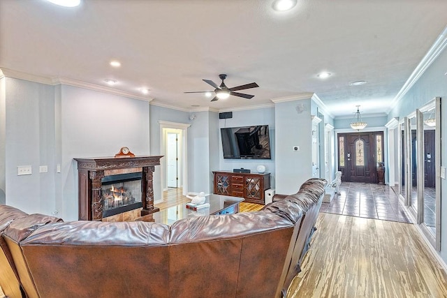 4206 NE Kenton Ave, Bentonville, AR 72712 - living area with light wood-type flooring, crown molding, ceiling fan, recessed lighting, and a premium fireplace