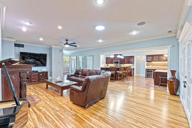 4206 NE Kenton Ave, Bentonville, AR 72712 - living room with light wood-style floors, a ceiling fan, recessed lighting, wine cooler, and ornamental molding