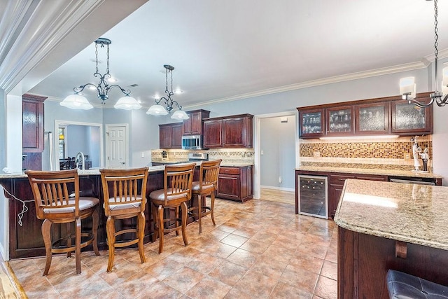 4206 NE Kenton Ave, Bentonville, AR 72712 - kitchen featuring wine cooler, stainless steel microwave, backsplash, a chandelier, and crown molding