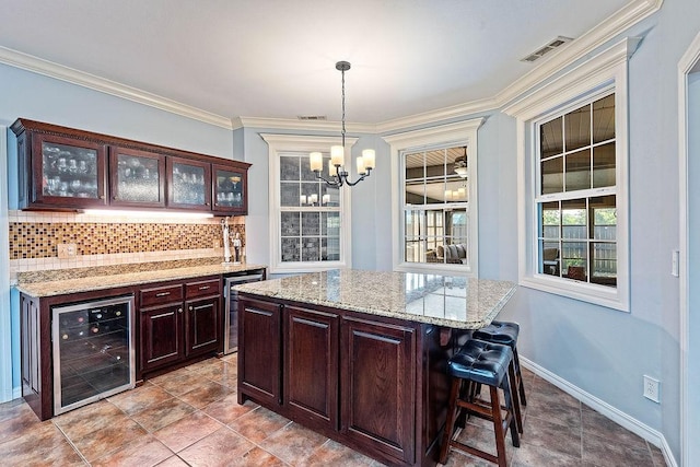 4206 NE Kenton Ave, Bentonville, AR 72712 - kitchen featuring wine cooler, backsplash, a chandelier, glass insert cabinets, and crown molding