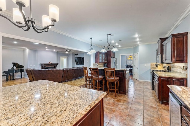4206 NE Kenton Ave, Bentonville, AR 72712 - kitchen with a chandelier, stainless steel appliances, decorative backsplash, recessed lighting, and a breakfast bar area