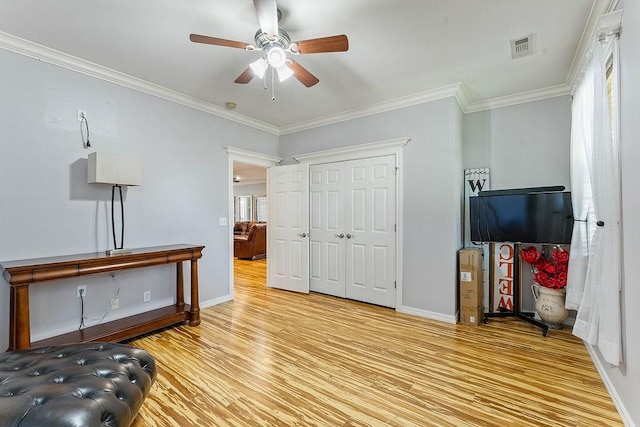 4206 NE Kenton Ave, Bentonville, AR 72712 - living area with wood finished floors, a ceiling fan, crown molding, and baseboards