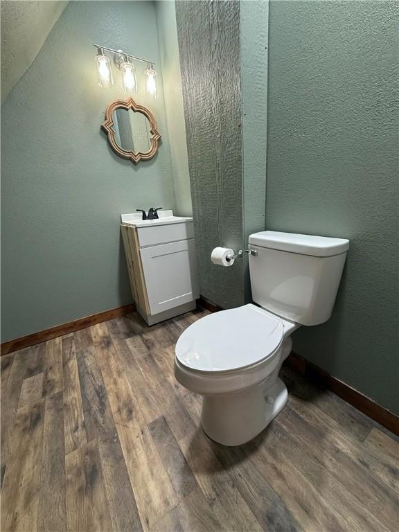 2711 Skyline Dr, Russellville, AR 72802 - bathroom with vanity, wood finished floors, toilet, and baseboards