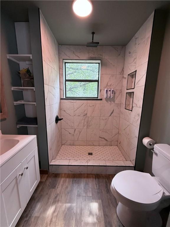 2711 Skyline Dr, Russellville, AR 72802 - bathroom with toilet, wood finished floors, a shower stall, and vanity