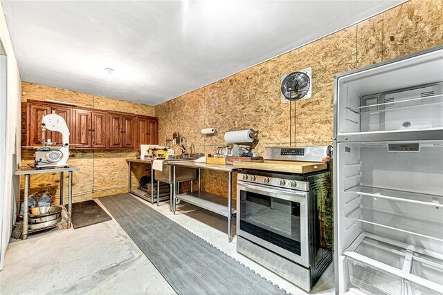 14620 Ravenwood Ln, Garfield, AR 72732 - kitchen featuring stainless steel range with electric cooktop, brown cabinets, and concrete flooring