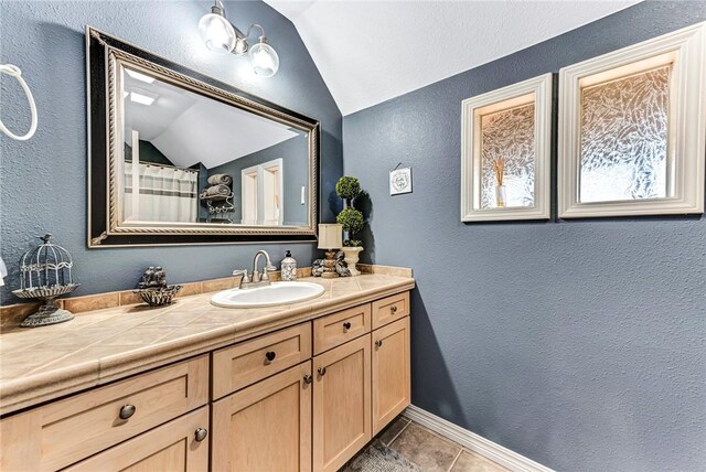 14620 Ravenwood Ln, Garfield, AR 72732 - full bathroom featuring lofted ceiling, a textured wall, vanity, and tile patterned floors