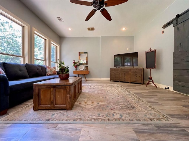 10059 Birdie St, Dardanelle, AR 72834 - living room with a barn door, ceiling fan, baseboards, and recessed lighting