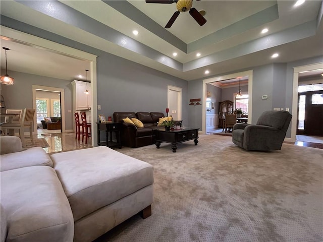 10059 Birdie St, Dardanelle, AR 72834 - living area with recessed lighting, light colored carpet, ceiling fan, and a tray ceiling
