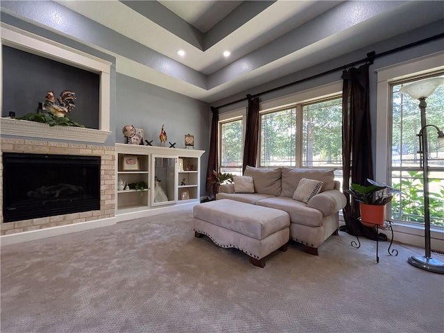 10059 Birdie St, Dardanelle, AR 72834 - living room featuring carpet, a tray ceiling, recessed lighting, and a fireplace