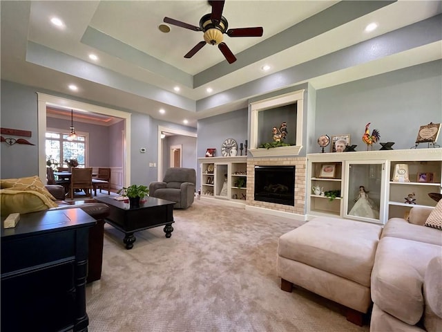10059 Birdie St, Dardanelle, AR 72834 - living area with carpet flooring, ceiling fan, a tray ceiling, recessed lighting, and a fireplace