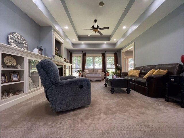 10059 Birdie St, Dardanelle, AR 72834 - carpeted living room with a ceiling fan, a fireplace, and a raised ceiling
