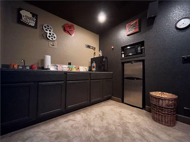 10059 Birdie St, Dardanelle, AR 72834 - bar area featuring light carpet, a textured wall, black microwave, and freestanding refrigerator