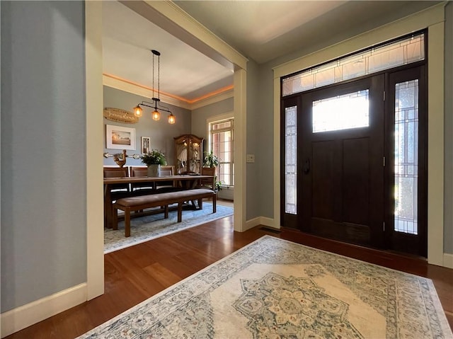 10059 Birdie St, Dardanelle, AR 72834 - foyer entrance with baseboards, dark wood-type flooring, and crown molding