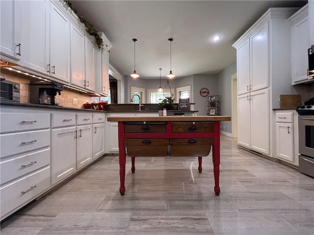 10059 Birdie St, Dardanelle, AR 72834 - kitchen with electric range, white cabinets, recessed lighting, decorative backsplash, and dark countertops