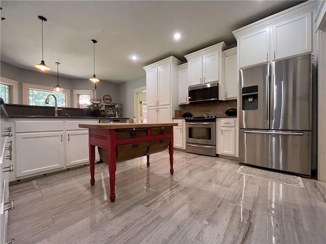 10059 Birdie St, Dardanelle, AR 72834 - kitchen featuring appliances with stainless steel finishes, white cabinets, decorative backsplash, dark countertops, and recessed lighting
