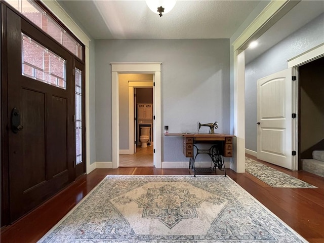 10059 Birdie St, Dardanelle, AR 72834 - foyer entrance featuring wood finished floors, baseboards, and stairs