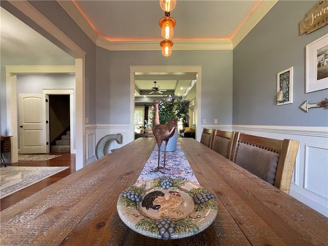 10059 Birdie St, Dardanelle, AR 72834 - dining space featuring ceiling fan, stairway, wainscoting, a decorative wall, and crown molding