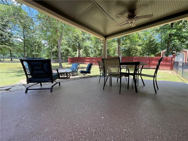 10059 Birdie St, Dardanelle, AR 72834 - view of patio with a ceiling fan, outdoor dining area, and view of scattered trees