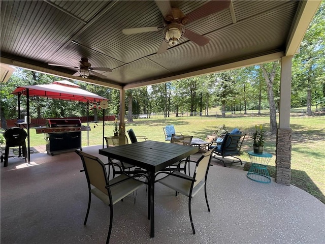 10059 Birdie St, Dardanelle, AR 72834 - view of patio / terrace with outdoor dining area, ceiling fan, grilling area, a gazebo, and view of wooded area