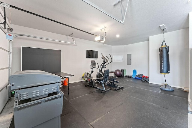 1904 Bergman Rd, Pea Ridge, AR 72751 - workout area featuring a garage, electric panel, and baseboards