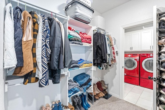 1904 Bergman Rd, Pea Ridge, AR 72751 - laundry area featuring separate washer and dryer, cabinet space, and light tile patterned flooring