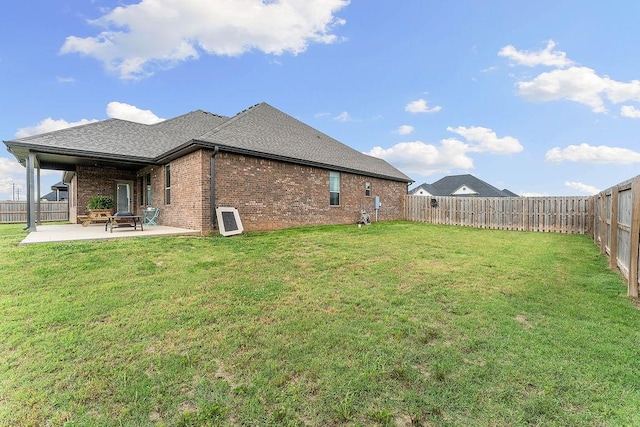 1904 Bergman Rd, Pea Ridge, AR 72751 - back of property with a patio area, brick siding, and a shingled roof