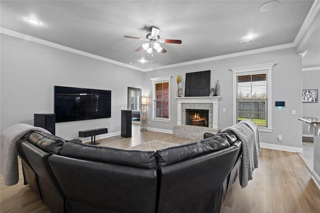 236 Ranalli Ave, Springdale, AR 72762 - living area featuring a lit fireplace, a ceiling fan, light wood finished floors, recessed lighting, and crown molding